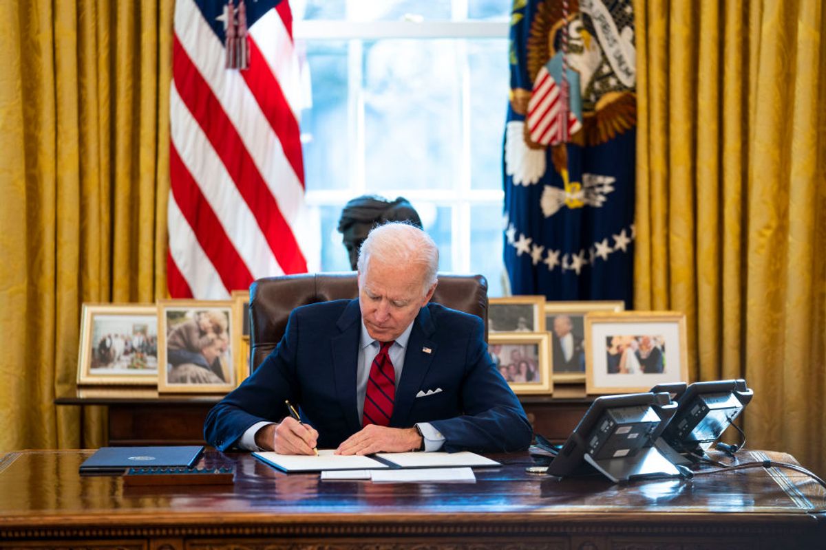 WASHINGTON, DC - JANUARY 28: U.S. President Joe Biden signs executive actions in the Oval Office of the White House on January 28, 2021 in Washington, DC. President Biden signed a series of executive actions Thursday afternoon aimed at expanding access to health care, including re-opening enrollment for health care offered through the federal marketplace created under the Affordable Care Act. (Photo by Doug Mills-Pool/Getty Images) (Getty Images)