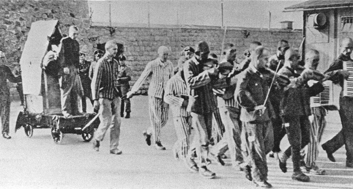 Prisoners are forced to give company to  fellow sufferers  with happy music  to execution. Mauthausen concentration camp. Austria. Photograph. Ca. 1943. (Photo by Votava/Imagno/Getty Images) . (Votava/Imagno/Getty Images)