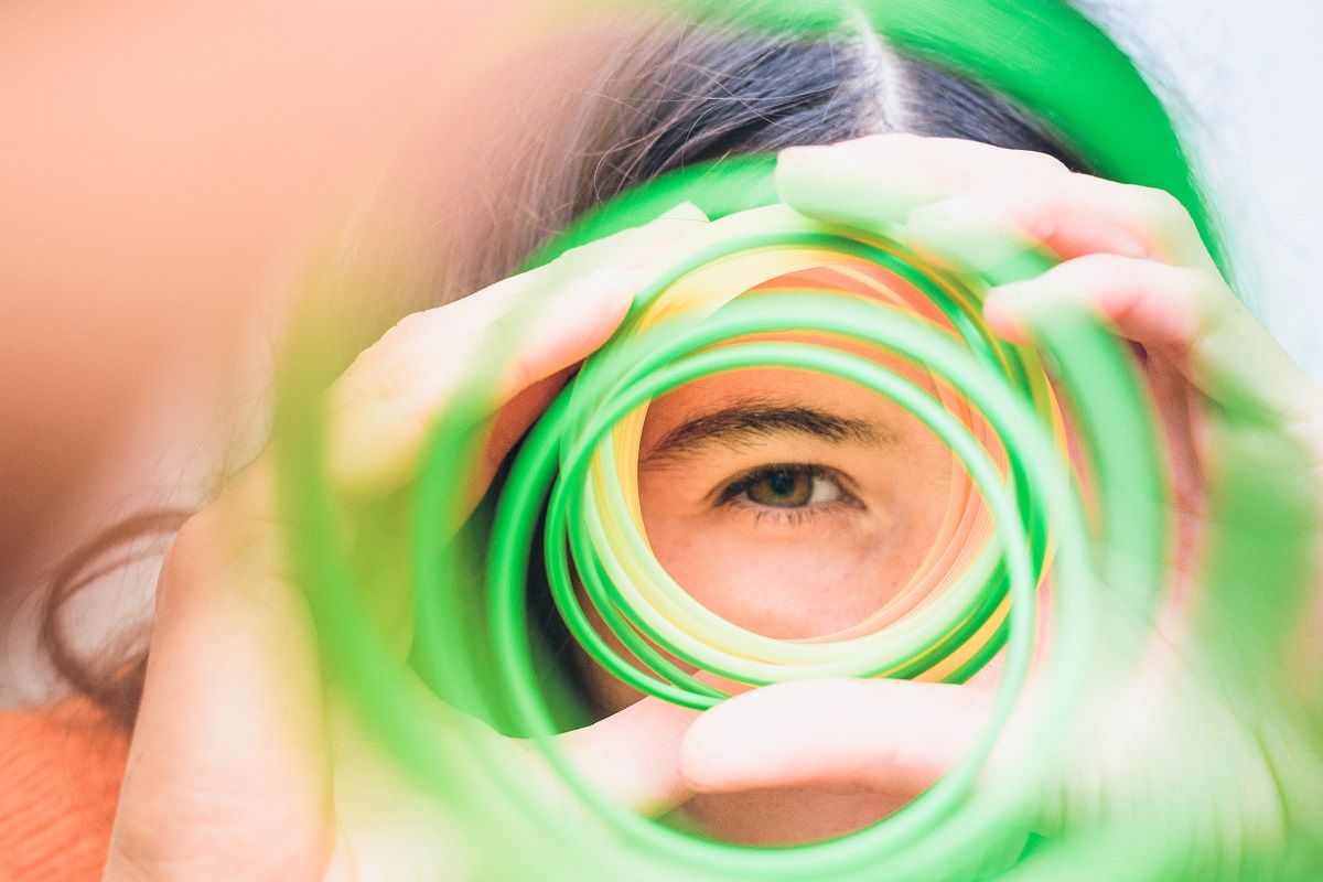 girl looking through a spiral of colors. (Crispin la valiente/Moment via Getty Images)