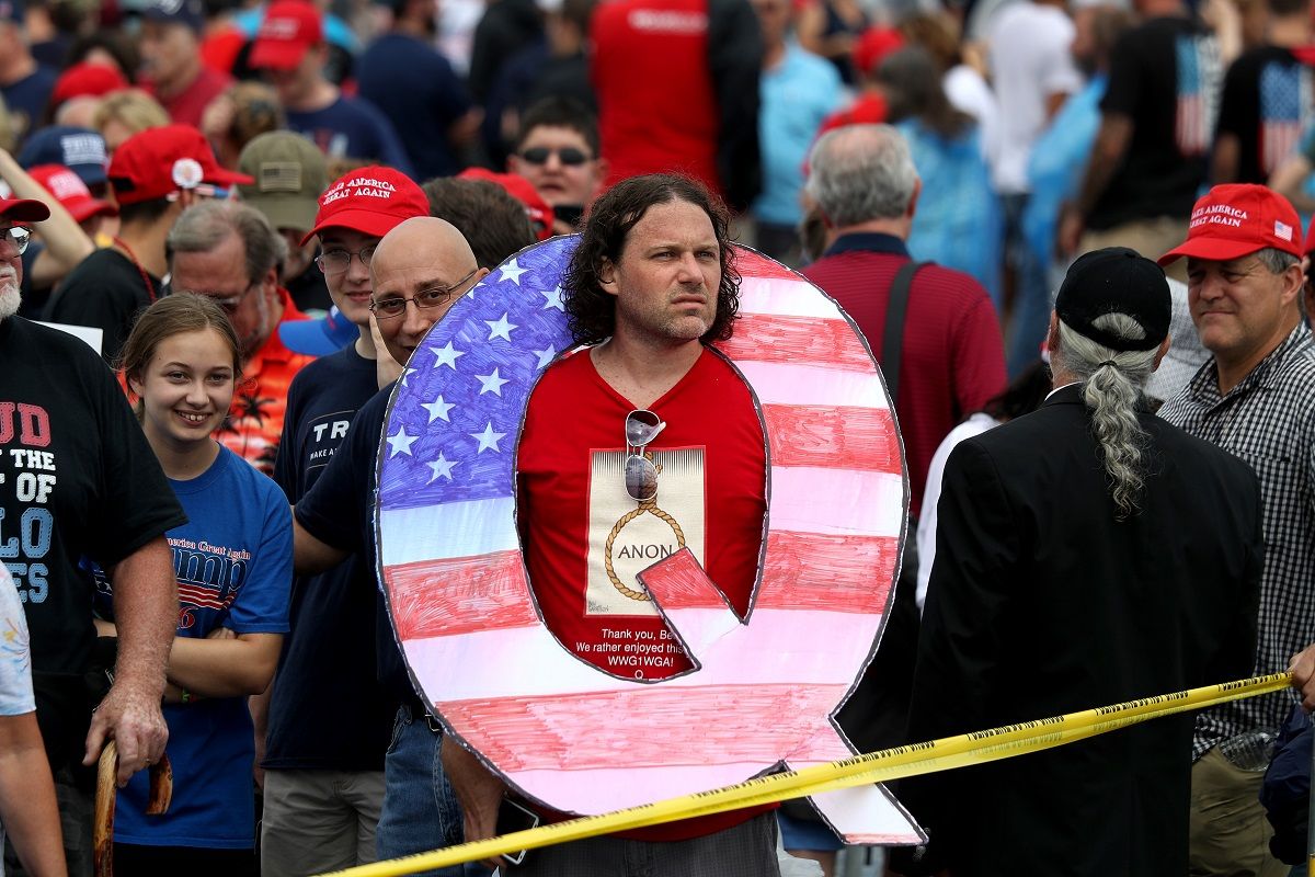 WILKES BARRE, PA - AUGUST 02: David Reinert holds a large "Q" sign while waiting in line on to see President Donald J. Trump at his rally August 2, 2018 at the Mohegan Sun Arena at Casey Plaza in Wilkes Barre, Pennsylvania. "Q" represents QAnon, a conspiracy theory group that has been seen at recent rallies. (Photo by Rick Loomis/Getty Images) (Rick Loomis/Getty Images)