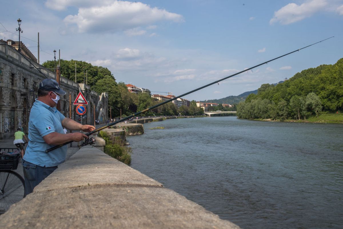 A fisherman in action on the Po riverside at Parco del Valentino (Valentino Park) during first weekend of phase two (2) of COVID-19 coronavirus emergency, in Turin, Italy, on May 9, 2020. During phase two Italians are allowed to return to work, to see their relatives, to do outdoor sports activities. (Photo by Mauro Ujetto/NurPhoto via Getty Images) (Mauro Ujetto/NurPhoto via Getty Images)