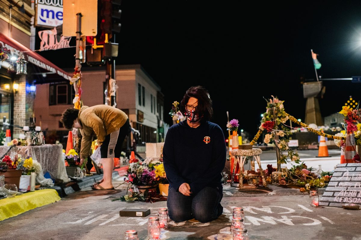 MINNEAPOLIS, MN - MARCH 29: Courteney Ross, girlfriend of George Floyd, lays candles in the intersection of 38th St. &amp; Chicago Ave on March 29, 2021 in Minneapolis, Minnesota. Opening statements begin today in the trial of former Minneapolis police officer Derek Chauvin who faces a second-degree murder charge in the death of George Floyd. (Photo by Brandon Bell/Getty Images) (Getty Images)