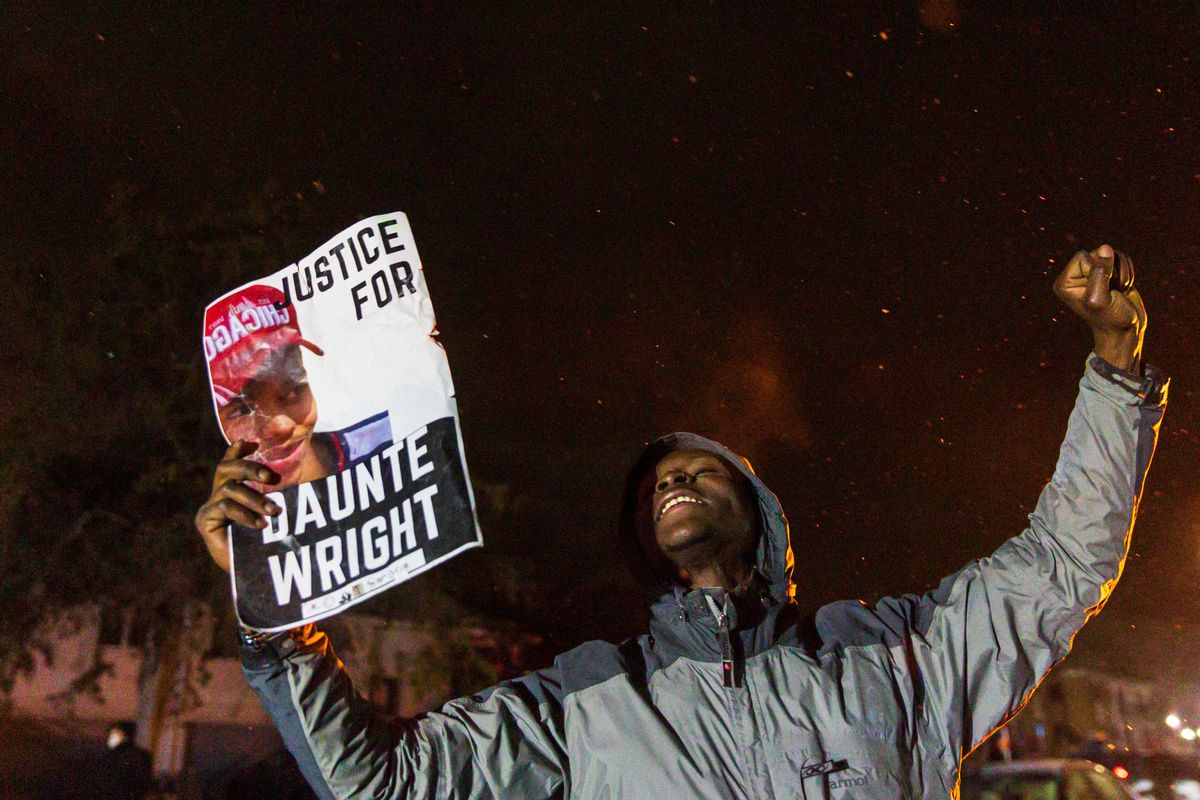 A demonstrator holds a photo of Daunte Wright and shout "Don't shoot" at the police after curfew as they protest the death of Daunte Wright who was shot and killed by a police officer in Brooklyn Center, Minnesota on April 13, 2021. - Tensions have soared over the death on April 11 of African American Daunte Wright near the Midwestern US city, a community already on edge over the ongoing trial of a policeman accused of killing another Black man, George Floyd. (Photo by Kerem YUCEL / AFP) (Photo by KEREM YUCEL/AFP via Getty Images) (Getty Images)
