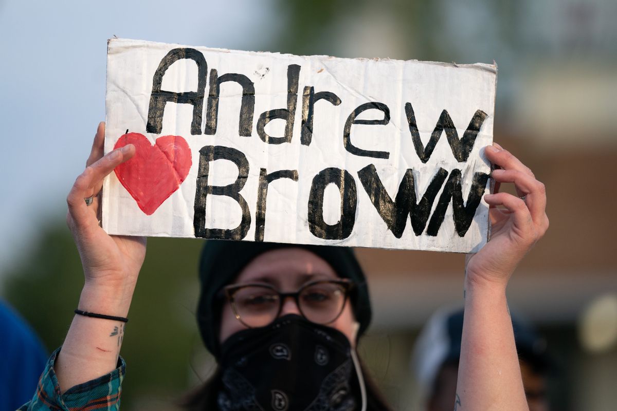 ELIZABETH CITY, NC - APRIL 22: A demonstrator holds a sign for Andrew Brown Jr. during a protest march on April 22, 2021 in Elizabeth City, North Carolina. The protest was sparked by the police killing of Brown on April 21. (Photo by Sean Rayford/Getty Images) (Getty Images)