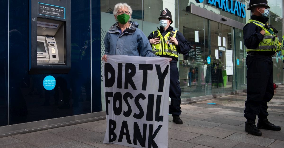 CARDIFF, WALES - SEPTEMBER 03: A woman holds a sign which says “dirty fossil bank” in front of Barclays Bank on the Hayes in Cardiff on September 3, 2020 in Cardiff, Wales. Extinction Rebellion are holding a week of mass rebellions from September 1, which aim to draw attention to environmental issues. (Photo by Matthew Horwood/Getty Images) (Matthew Horwood/Getty Images)
