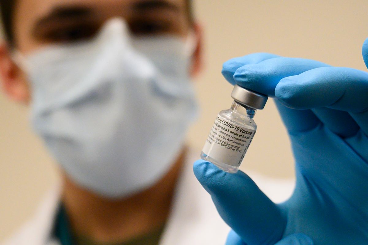 Army Spc. Angel Laureano holds a vial of the COVID-19 vaccine, Walter Reed National Military Medical Center, Bethesda, Md., Dec. 14, 2020. (DoD photo by Lisa Ferdinando) (U.S. Secretary of Defense/Public Domain)