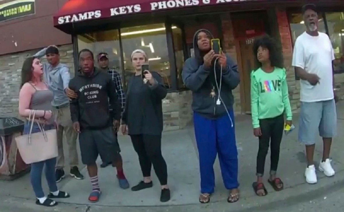 FILE - This May 25, 2020, file image from a police body camera shows bystanders including Alyssa Funari, left filming, Charles McMillan, center left in light colored shorts, Christopher Martin center in gray, Donald Williams, center in black, Genevieve Hansen, fourth from right filming, Darnella Frazier, third from right filming, as former Minneapolis police officer Derek Chauvin was recorded pressing his knee on George Floyd's neck for several minutes in Minneapolis. To the prosecution, the witnesses who watched Floyd's body go still were regular people -- a firefighter, a mixed martial arts fighter, a high school student and her 9-year-old cousin in a T-shirt emblazoned with the word "Love." (Minneapolis Police Department via AP, File) (Minneapolis Police Department via AP, File)