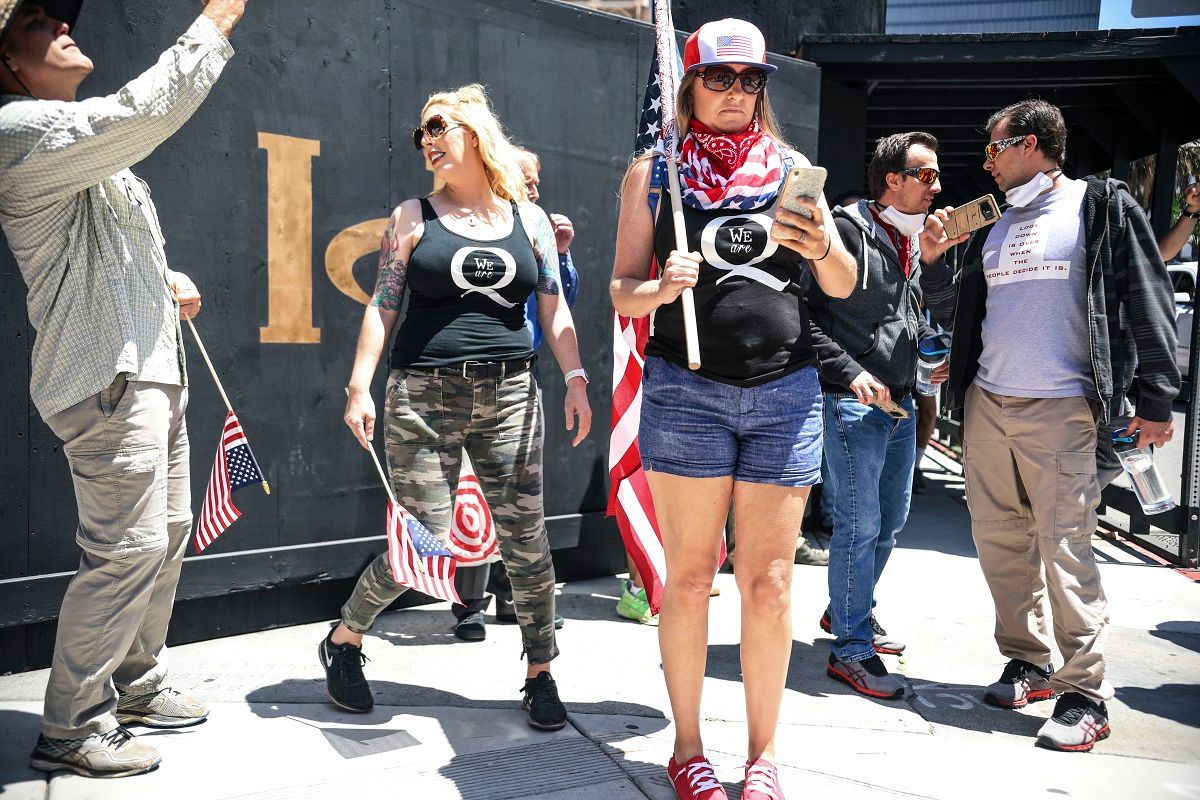 Conspiracy theorist QAnon demonstrators protest during a rally to re-open California and against Stay-At-Home directives on May 1, 2020 in San Diego, California. - Rallies have been held at several state capitols across the country as protesters express their deep frustration with the stay-at-home orders that are meant to stem the spread of the novel coronavirus. (Photo by Sandy Huffaker / AFP) (Photo by SANDY HUFFAKER/AFP via Getty Images) (Sandy Huffaker/AFP via Getty Images)