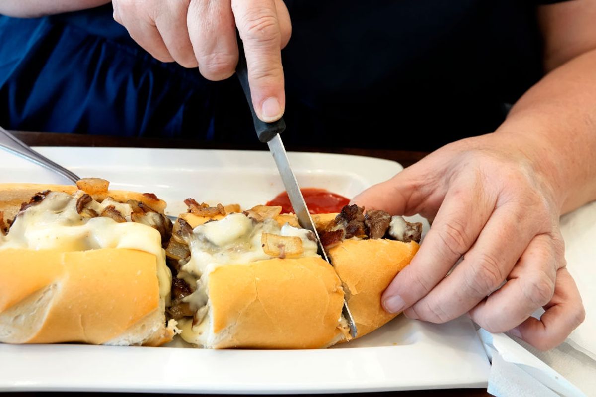 Miami Beach, Manolo, Argentinean restaurant, cutting cheese steak sandwich. (Photo by: Jeffrey Greenberg/Universal Images Group via Getty Images) (Getty Images/Stock photo)