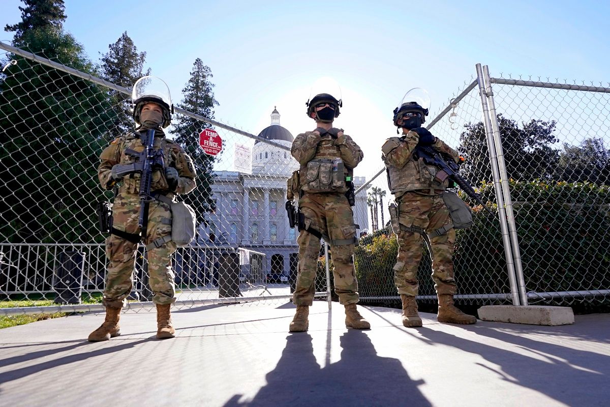 FILE - In this Jan. 19, 2021, file photo, California National Guard members stand guard at an access point to the California state Capitol in Sacramento, Calif. Law enforcement officials are investigating escalating threats of death and violence against California Gov. Gavin Newsom, his family and the the wineries, shops and other businesses he founded. (AP Photo/Rich Pedroncelli, File) (AP Photo / Rich Pedroncelli)