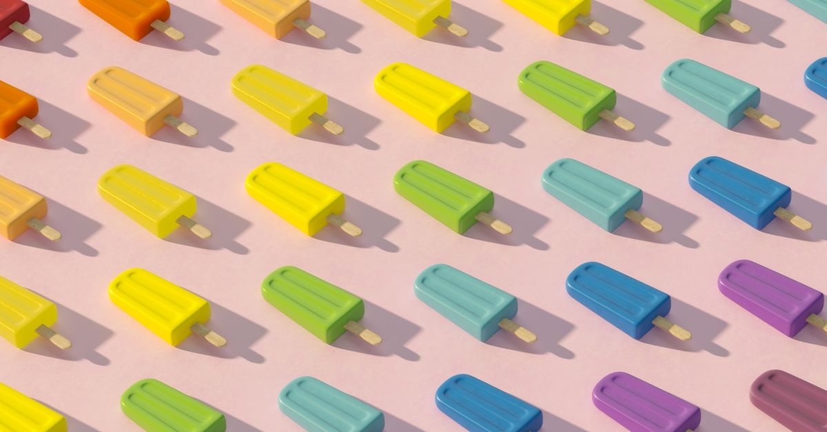 Digital generated image of Popsicles organized into rainbow colored pattern on pink surface. (Getty Images)
