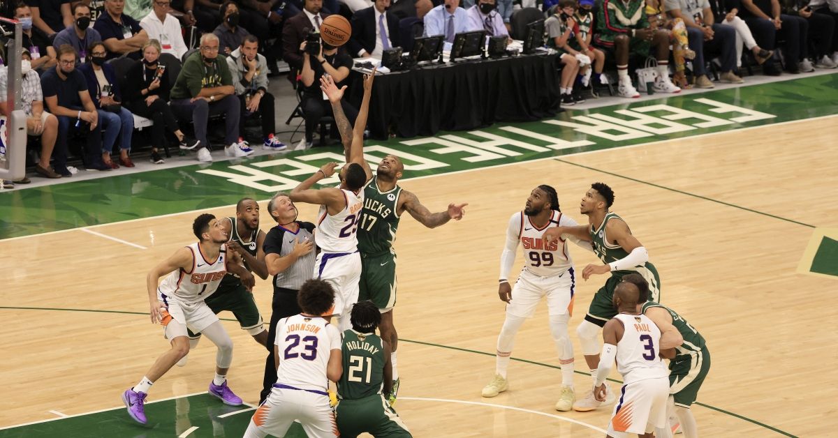 MILWAUKEE, WISCONSIN - JULY 11: Mikal Bridges #25 of the Phoenix Suns and P.J. Tucker #17 of the Milwaukee Bucks go up for a jump ball during the second half in Game Three of the NBA Finals at Fiserv Forum on July 11, 2021 in Milwaukee, Wisconsin. NOTE TO USER: User expressly acknowledges and agrees that, by downloading and or using this photograph, User is consenting to the terms and conditions of the Getty Images License Agreement. (Photo by Justin Casterline/Getty Images) (Justin Casterline/Getty Images)