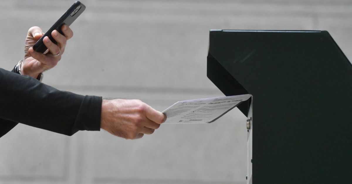 PHILADELPHIA, PA - OCTOBER 27:  A man photographs himself depositing his ballot in an official ballot drop box while a long line of voters queue outside of Philadelphia City Hall at the satellite polling station on October 27, 2020 in Philadelphia, Pennsylvania.  With the election only a week away, this new form of in-person voting by using mail ballots has enabled tens of millions of voters to cast their ballots before the general election. Vying to recapture the Keystone State's vital 20 electoral votes in order to bolster his reelection prospects, President Donald Trump held three rallies throughout Pennsylvania yesterday.  (Photo by Mark Makela/Getty Images) (Getty Images)