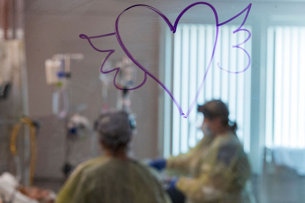 TOPSHOT - A heart with wings is drawn on the window as nurses care for a Covid-19 patient inside the ICU (intensive care unit) at Adventist Health in Sonora, California on August 27, 2021. - The hospital has had 72 hospitalizations due to Covid-19 since August 1, 2021, of which 11 have died from complications of the virus. (Photo by Nic Coury / AFP) (Photo by NIC COURY/AFP via Getty Images) (NIC COURY/AFP via Getty Images)