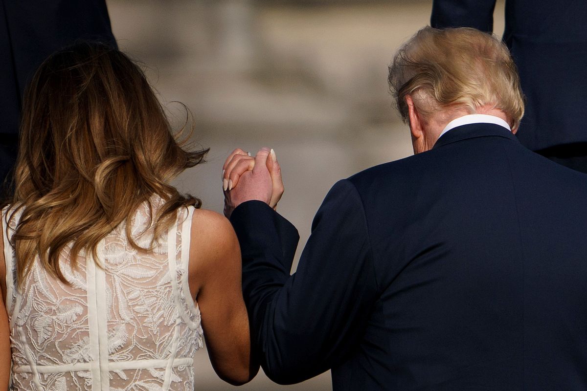 US First Lady Melania Trump (L) holds hands with US President Donald Trump ahead of a working dinner at The Parc du Cinquantenaire - Jubelpark Park in Brussels on July 11, 2018, during the North Atlantic Treaty Organization (NATO) summit. (Photo by Brendan Smialowski / AFP)        (Photo credit should read BRENDAN SMIALOWSKI/AFP via Getty Images) (BRENDAN SMIALOWSKI/AFP via Getty Images)