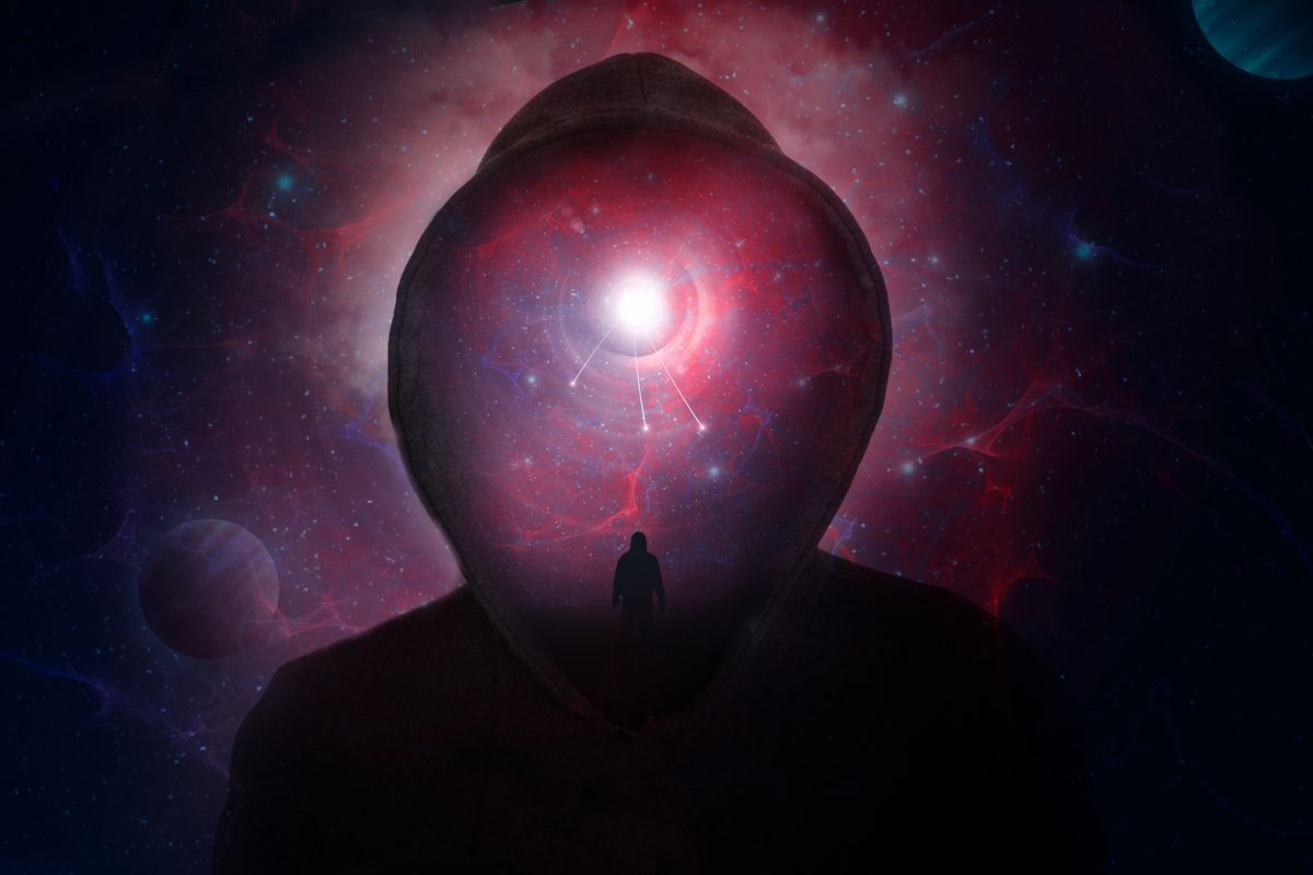 A science fiction concept of a hooded figure without a face. Over layered with a man looking into a universe of stars and planets. (Getty Images)