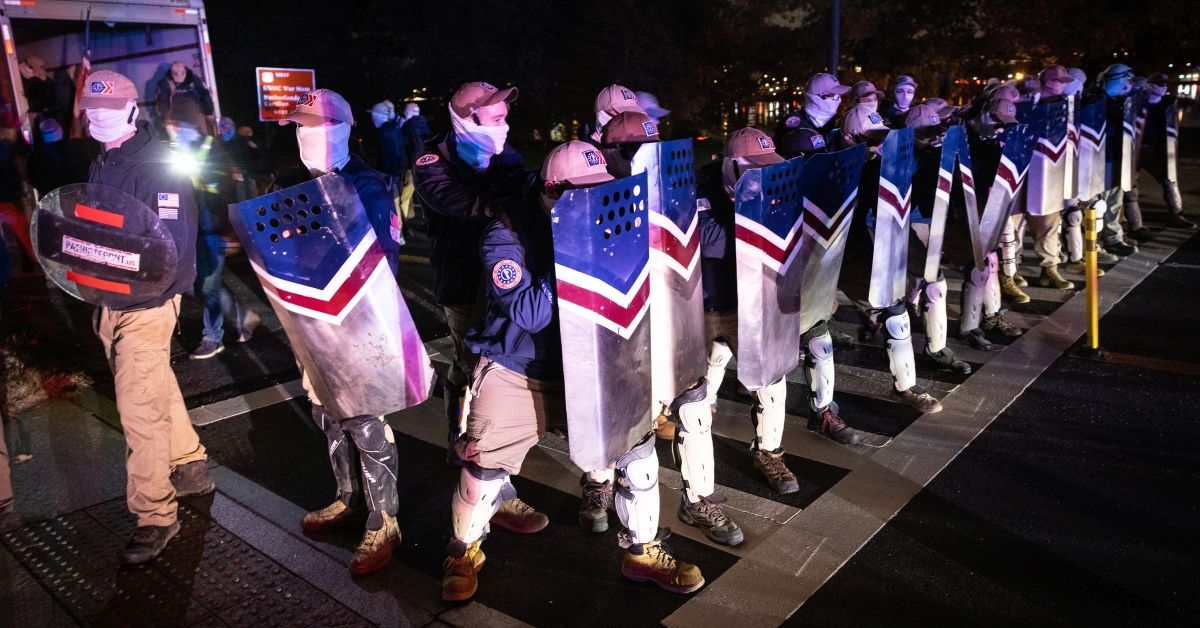 ARLINGTON, VIRGINIA - DECEMBER 04: Members of the rightwing group Patriot Front wait along the George Washington Parkway near Arlington Cemetery after marching on the National Mall on December 04, 2021 in Arlington, Virginia. Patriot Front broke off of the white nationalist group Vanguard America after the deadly “Unite the Right” rally in Charlottesville, Virginia in 2017. (Photo by Win McNamee/Getty Images) (Win McNamee/Getty Images)