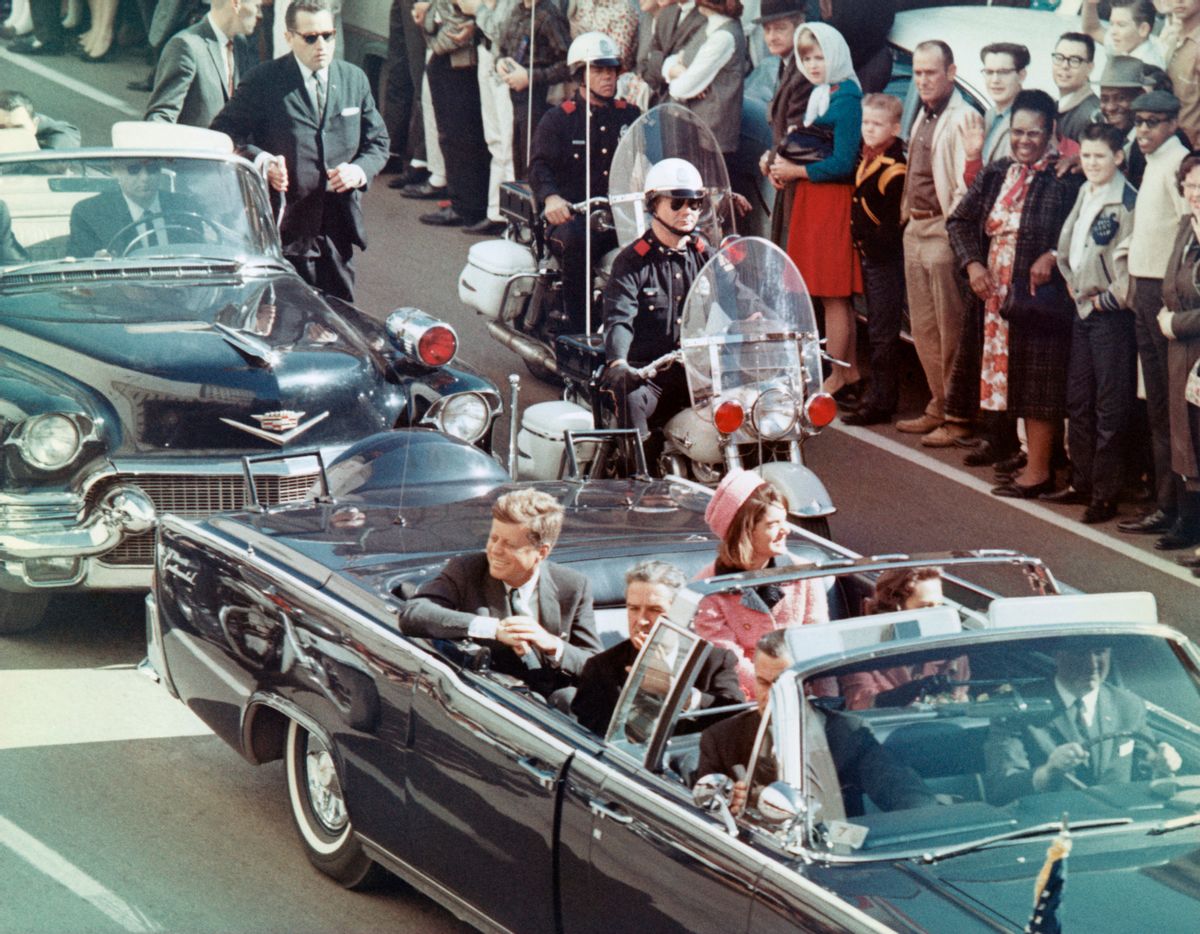 President and Mrs. John F. Kennedy smile at the crowds lining their motorcade route in Dallas, Texas, on November 22, 1963. Minutes later the President was assassinated as his car passed through Dealey Plaza. (Bettmann / Contributor)