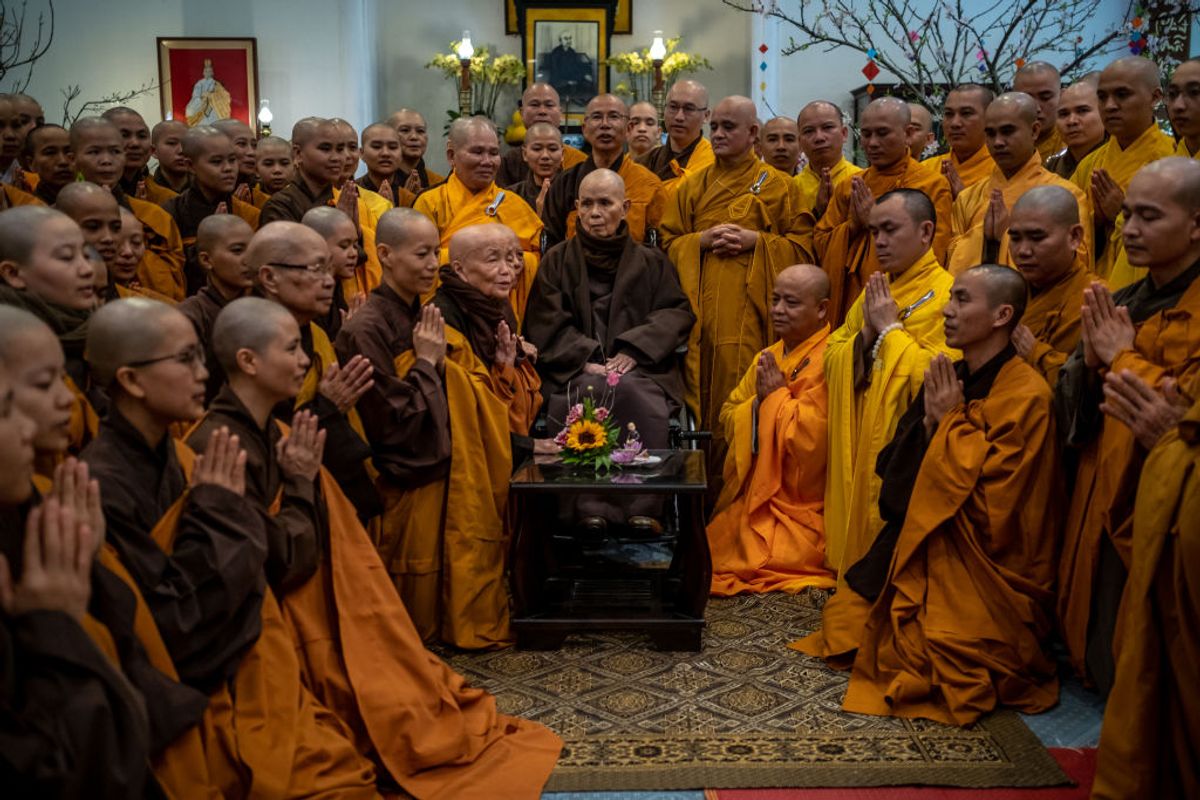 HUE, VIETNAM - JANUARY 25: Buddhist monks and nuns greet zen master Thich Nhat Hanh (center) at a praying ceremony marking the first day of Lunar New Year at Tu Hieu temple on January 25, 2020 in Hue, Vietnam. As one of the most important figures in the fields of mindfulness, meditation and Zen Buddhism, the 93-year-old Vietnamese Buddhist monk Thich Nhat Hanh has had a major influence around the world. His human rights and reconciliation work during the Vietnam War led Martin Luther King Jr. to nominate him for a Nobel Prize. He is now back in the temple where he took his vows at 16, after 40 years of exile, to live his final days. The Lunar New Year also known as the Spring Festival, which is based on the Lunisolar Chinese calendar, falls on January 25 this year and marks the Year of the Rat. (Photo by Linh Pham/Getty Images) (Getty Images)