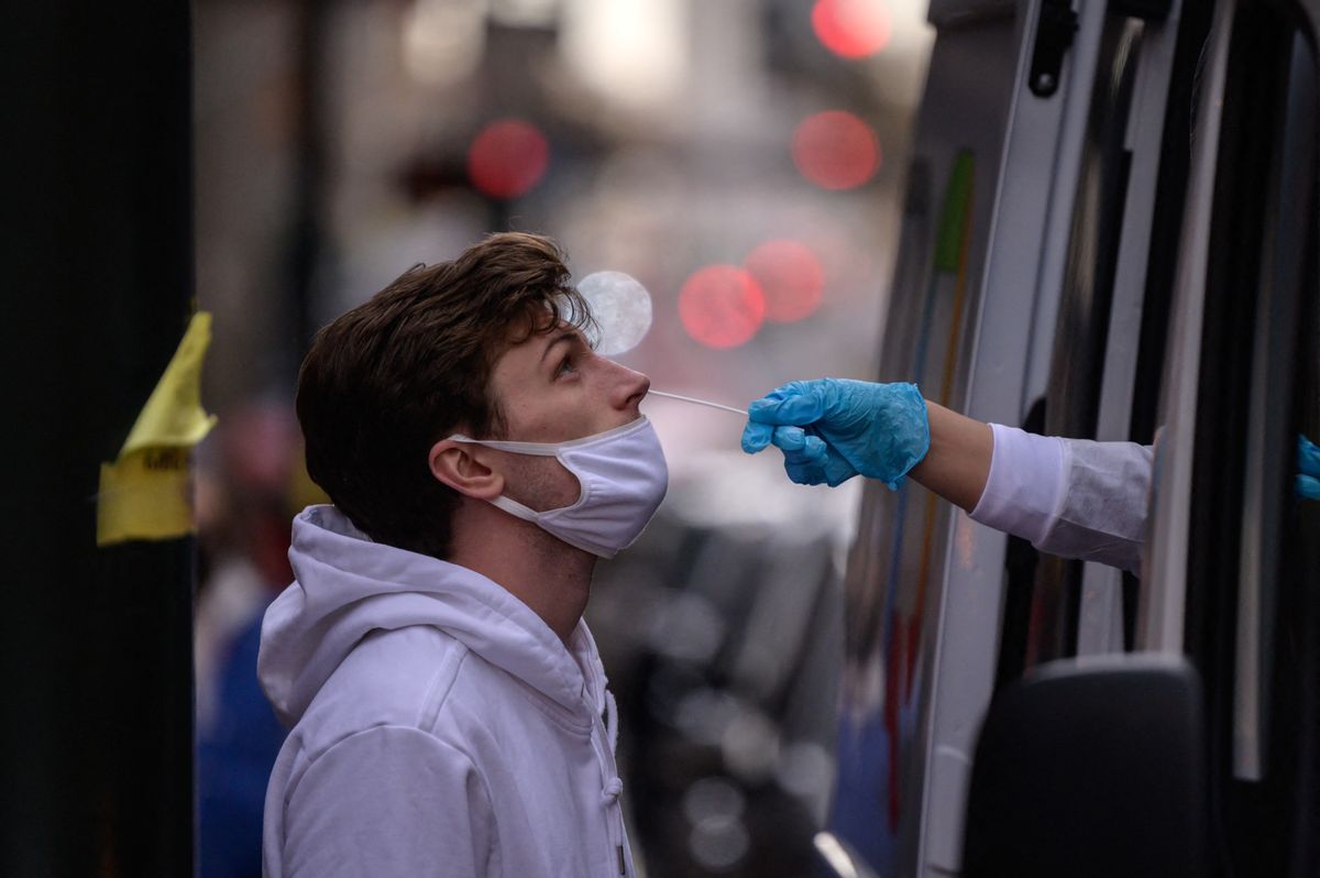 A man receives a nasal swab during a test for Covid-19 at a street-side testing booth in New York on December 17, 2021 (Photo by Ed JONES / AFP) (Photo by ED JONES/AFP via Getty Images) (Getty Images)