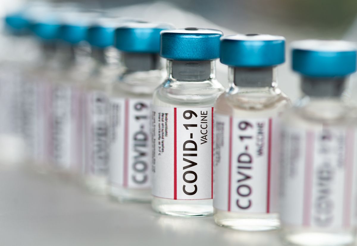 Covid-19 Coronavirus Vaccine vials in a row macro close up ( MarsBars/Getty Images)