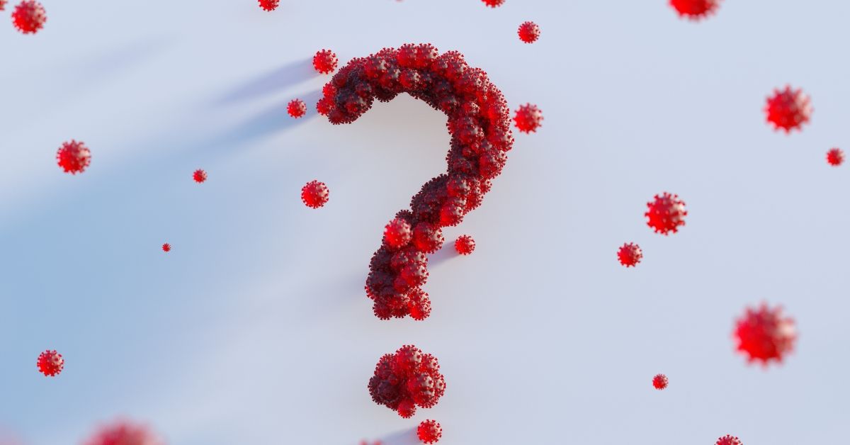 Digital generated image of semi transparent red Covid-19 cells connecting together and forming question mark against white background. (Getty Images)