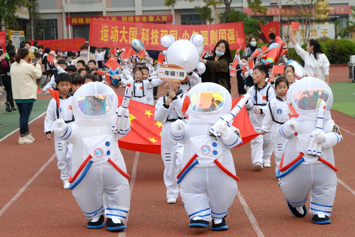 HUAIBEI, CHINA - OCTOBER 28: Students wearing astronaut costume march in formation during a sports meeting of a primary school on October 28, 2021 in Huaibei, Anhui Province of China. (Photo by Wan Shanchao/VCG via Getty Images) (Wan Shanchao/VCG via Getty Images)