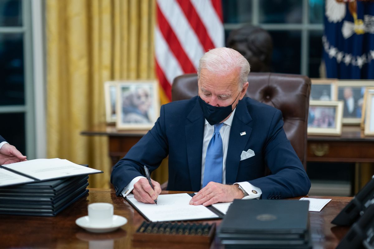 P20210120AS-6164: President Joe Biden signs one of the 17 Executive Orders he signed on Inauguration Day Wednesday, Jan. 20, 2021, in the Oval Officeof the White House. (Official White House Photo by Adam Schultz) (The White House/Wikimedia Commons)