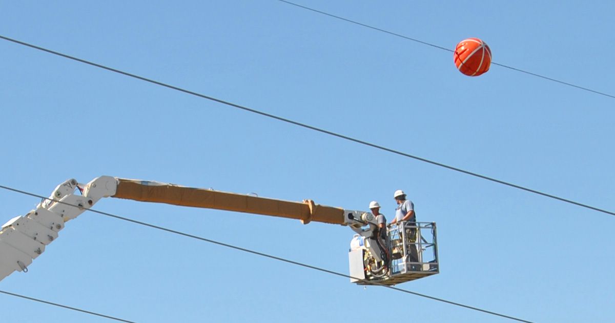 Colored balls on power lines whether red orange white or yellow are for aircraft safety and are often referred to as marker or visibility balls. (Courtesy: Western Area Power/Flickr) (Lisa Meiman/Western Area Power (Flickr))