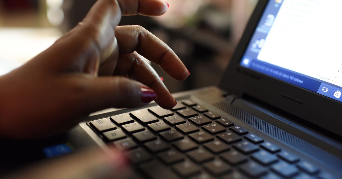 A woman uses a laptop on April 3, 2019, in Abidjan. - According to the figures of the platform of the fight against cybercrime (PLCC) of the national police, nearly one hundred crooks of the internet, were arrested in 2018 in Ivory Coast, a country known for its scammers on the web, has announced on April 2, 2019 the Ivorian authority of regulation of the telephony. (Photo by ISSOUF SANOGO / AFP)        (Photo credit should read ISSOUF SANOGO/AFP via Getty Images) (Getty Images)
