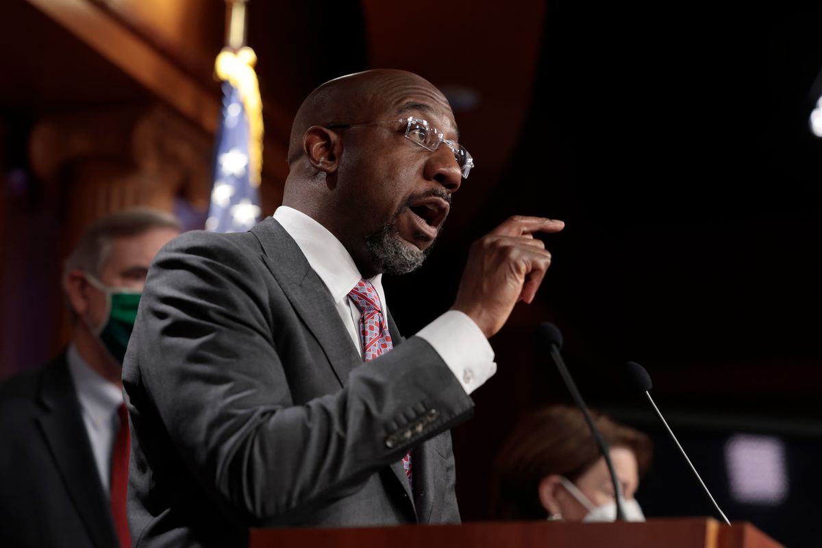 WASHINGTON, DC - JANUARY 04: Sen. Raphael Warnock (D-GA) gestures as he speaks at a news conference following a virtual weekly Senate Democratic Policy meeting at the U.S. Capitol Building on January 04, 2022 in Washington, DC. During the news conference Schumer, along with other senators, spoke on numerous topics including future votes on voting rights legislation. (Photo by Anna Moneymaker/Getty Images) (Anna Moneymaker/Getty Images)