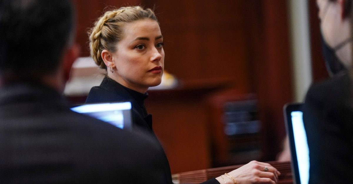 US actress Amber Heard looks over he shoulder during the 50 million US dollars Depp vs Heard defamation trial at the Fairfax County Circuit Court in Fairfax, Virginia,on April 14, 2022. - Heard is being sued for defamation by her former husband, US actor Johnny Depp, after she wrote an op-ed in The Washington Post in 2018 that, without naming Depp, accused him of domestic abuse. (Photo by Shawn THEW / POOL / AFP) (Photo by SHAWN THEW/POOL/AFP via Getty Images) (SHAWN THEW/POOL/AFP via Getty Images)