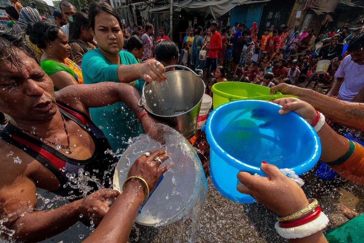 People are seen filling water from a municipal tanker on a hot day in Kolkata , India , on 16 April 2022 . Meteorological department of India has issued warning for heat wave and very high temperature along with water shortage in many part of the country according to media report. (Photo by Debarchan Chatterjee/NurPhoto via Getty Images) (Debarchan Chatterjee/NurPhoto via Getty Images))