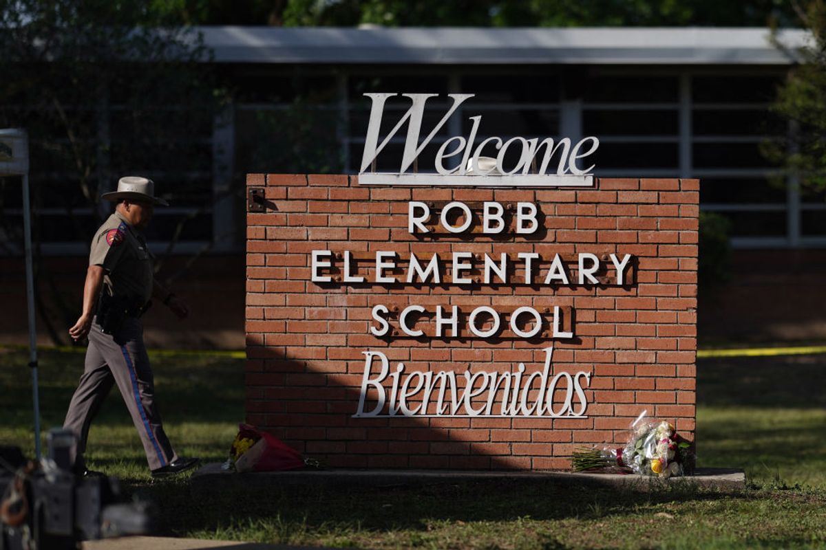 An officer walks outside of Robb Elementary School in Uvalde, Texas, on May 25, 2022. - A tight-knit Latino community in Texas was wracked with grief Wednesday after a teen in body armor marched into an elementary school and killed 19 small children and two teachers, in the latest spasm of deadly gun violence in America. (Photo by allison dinner / AFP) (Photo by ALLISON DINNER/AFP via Getty Images) (ALLISON DINNER/AFP via Getty Images)