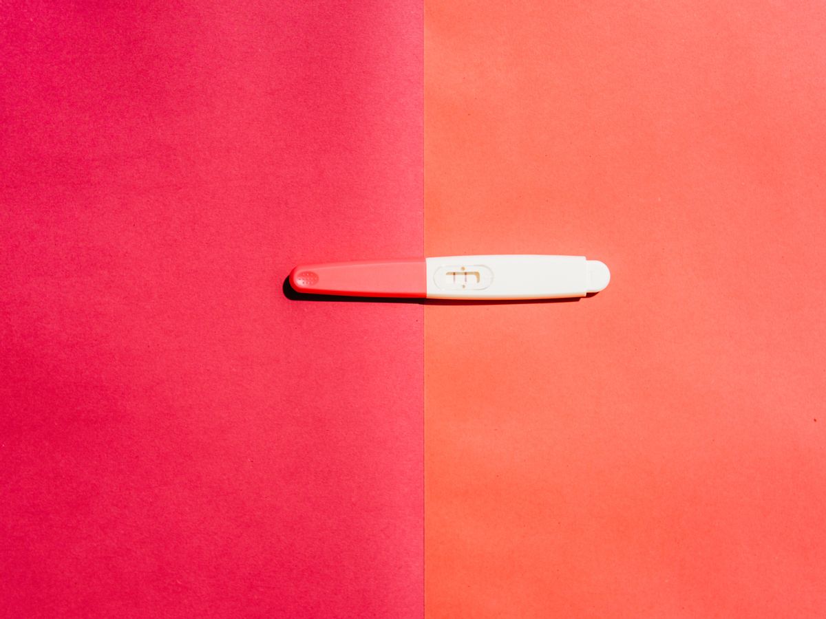 Pregnancy test on pink background.