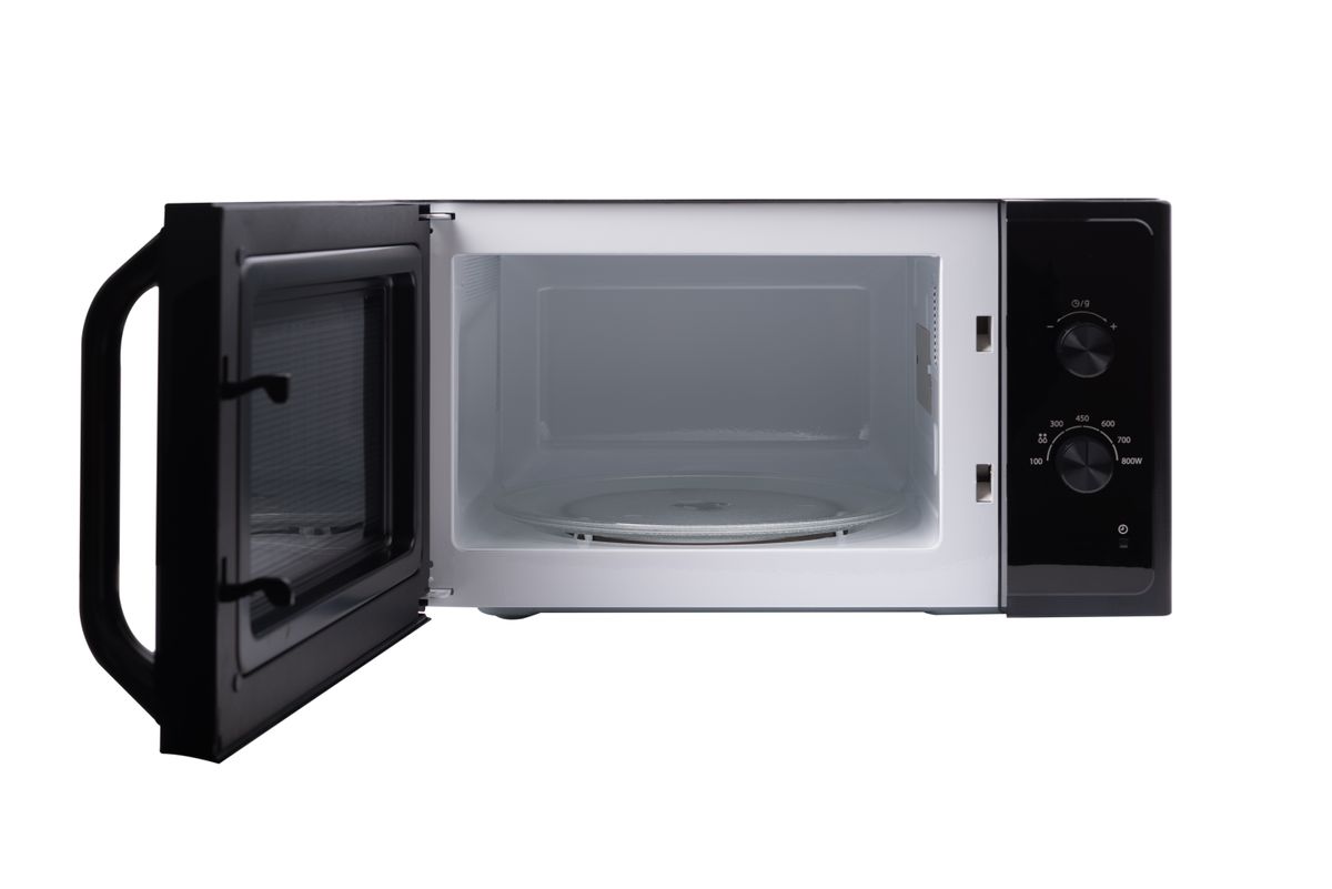open microwave oven isolated on a white background (Issarawat Tattong / Getty Images)