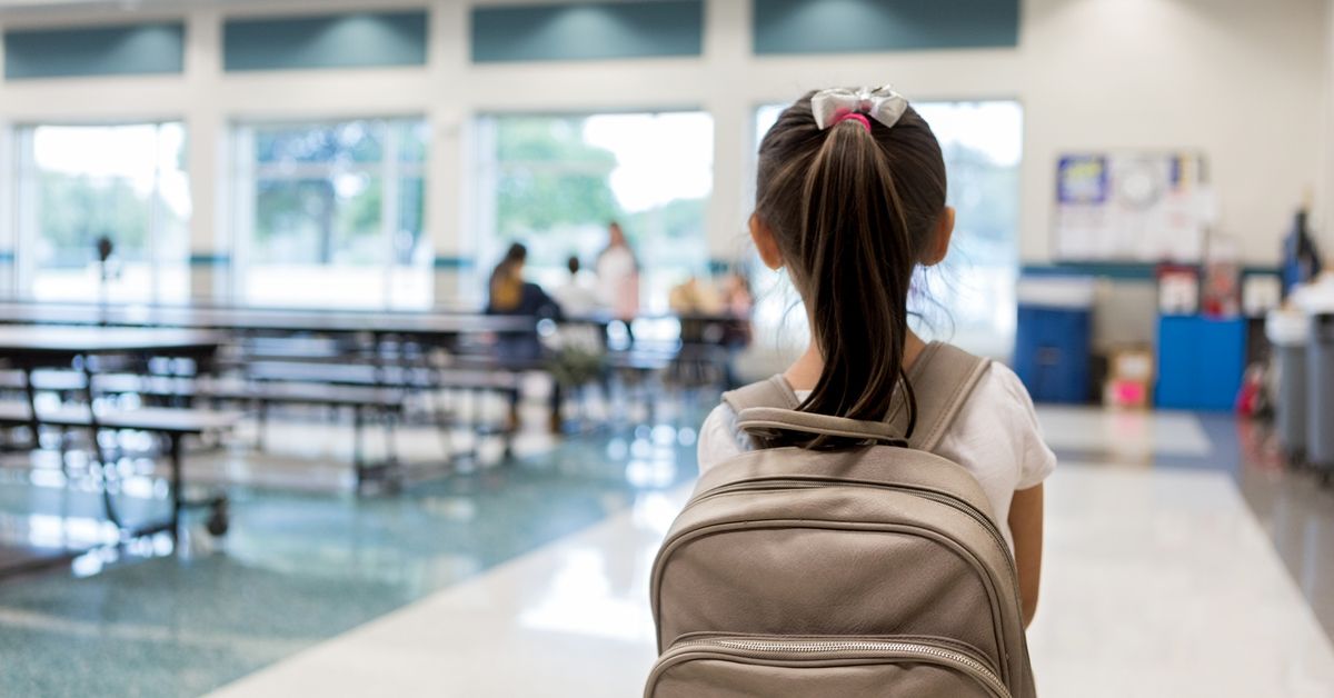 Elementary schoolgirl enters the school cafeteria. She pauses while looking for a friend. (Stock Photo/Getty Images)