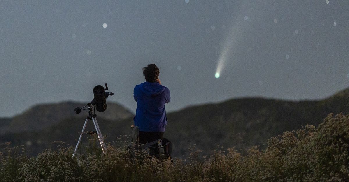 LOS ANGELES, CA - JULY 19:  A man with a telescope watches the night sky as Comet NEOWISE appears over the San Gabriel Mountains National Monument on July 19, 2020 northwest of Los Angeles, California. Also known as C/2020 F3 (NEOWISE), the three-mile-wide comet will come closest to Earth on  on July 22 before receding into space, to return 6,800 years from now.  (Photo by David McNew/Getty Images) (Getty Images)