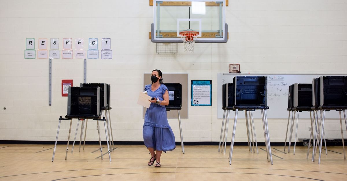 FAYETTEVILLE, NC - MAY 17: A woman walks her ballot to be counted after voting on May 17, 2022 in Cary, North Carolina. A slow but steady stream of people began voting early Tuesday morning for the midterm primary elections in Wake County. (Photo by Melissa Sue Gerrits/Getty Images) (Getty Images)