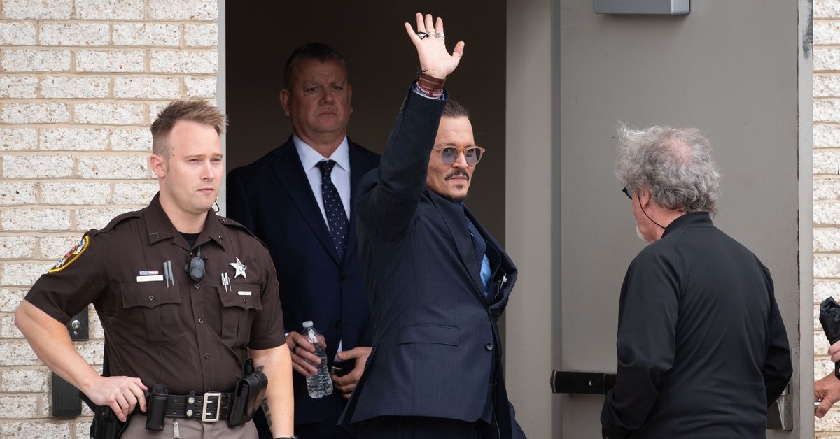 FAIRFAX, VA - MAY 27: (NY &amp; NJ NEWSPAPERS OUT) Johnny Depp waves to his fans during a recess outside court during the Johnny Depp and Amber Heard civil trial at Fairfax County Circuit Court on May 27, 2022 in Fairfax, Virginia. Depp is seeking $50 million in alleged damages to his career over an op-ed Heard wrote in the Washington Post in 2018.(Photo by Cliff Owen/Consolidated News Pictures/Getty Images) (Getty Images)