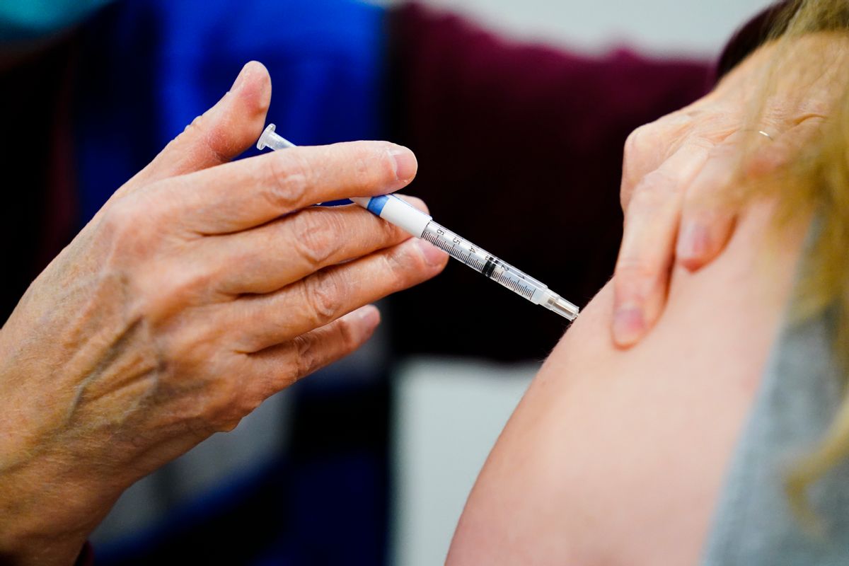 FILE - A health worker administers a dose of a COVID-19 vaccine during a vaccination clinic at the Keystone First Wellness Center in Chester, Pa., on Dec. 15, 2021. Government advisers are debating Tuesday, June 28, 2022, if Americans should get a modified COVID-19 booster shot this fall — one that better matches more recent virus variants. (AP Photo/Matt Rourke, File) (AP Photo/Matt Rourke)