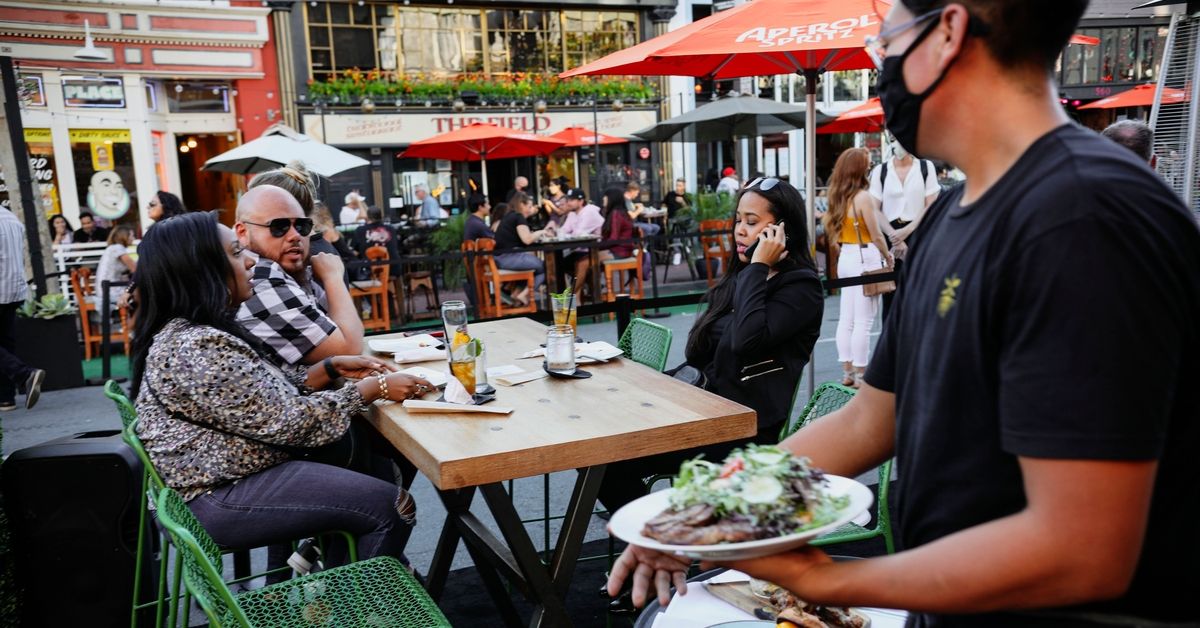 Patrons dine at an outdoor restaurant along 5th Avenue in The Gaslamp Quarter in downtown San Diego, California on, July 17, 2020. - California drastically rolled back its reopening plans Monday as coronavirus cases surged across dozens of US states and the World Health Organization warned that too many nations are mismanaging their pandemic response. (Photo by Sandy Huffaker / AFP) (Photo by SANDY HUFFAKER/AFP via Getty Images) (Getty Images)