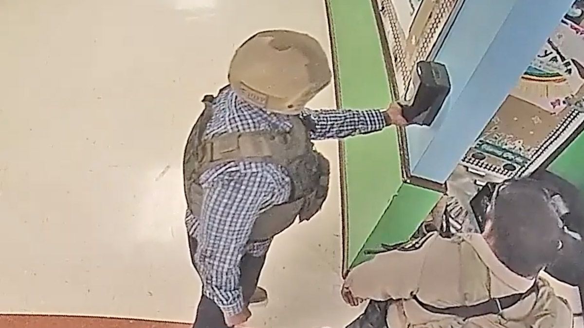 Surveillance video really did show a man who may have been a police officer using a hand sanitizer station while other officers waited a total of 80 minutes before engaging the shooter at Robb Elementary School in Uvalde, Texas. (Austin American-Statesman (YouTube))