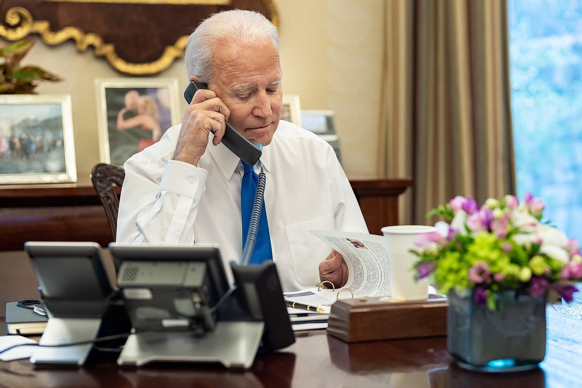 President Joe Biden prepares for phone calls with January 6th Heros, Thursday, January 6, 2022, in the Oval Office Dining Room of the White House. (Official White House Photo by Adam Schultz) (The White House/Wikimedia Commons)