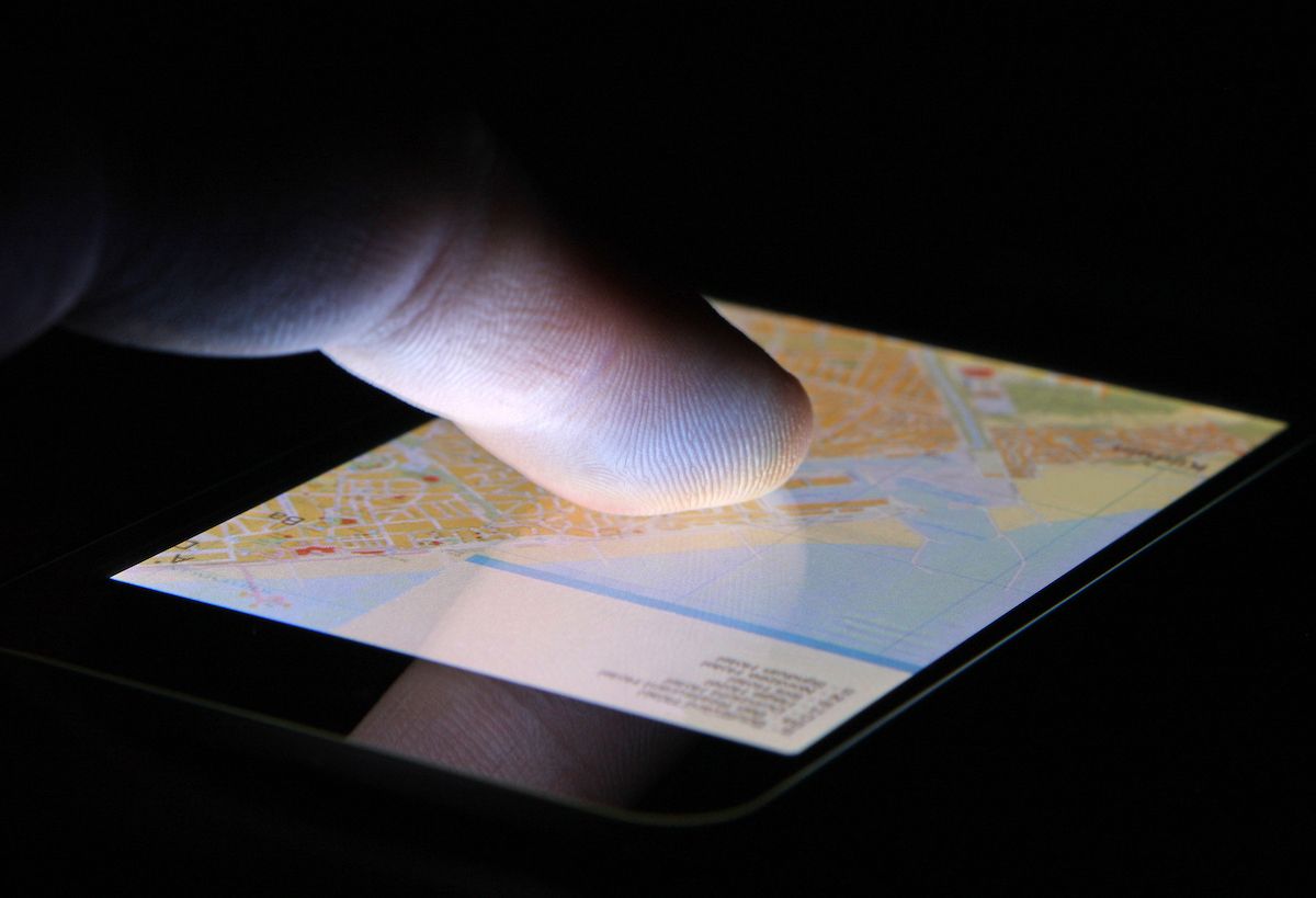 Finger touching navigation map on touch screen smart phone device. (Getty Images/Stock Photo)