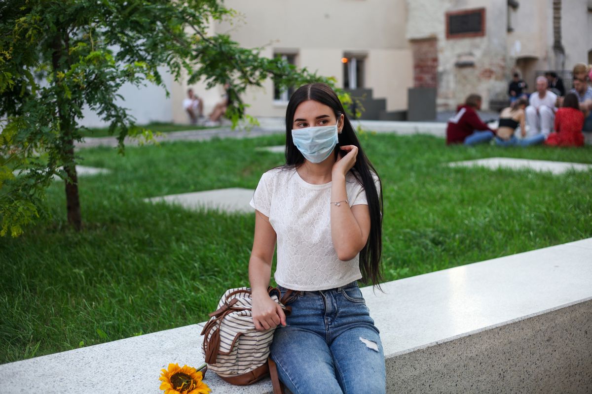 Street summer portrait of young woman with long black hair in blue jeans and white t-shirt. Summer fashion, lifestyles concept. (Getty Images/Stock photo)