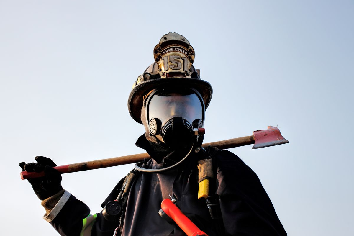 Firefighter holding axe. Fire prevention and extinguishing concept. (Getty Images/Stock photo)