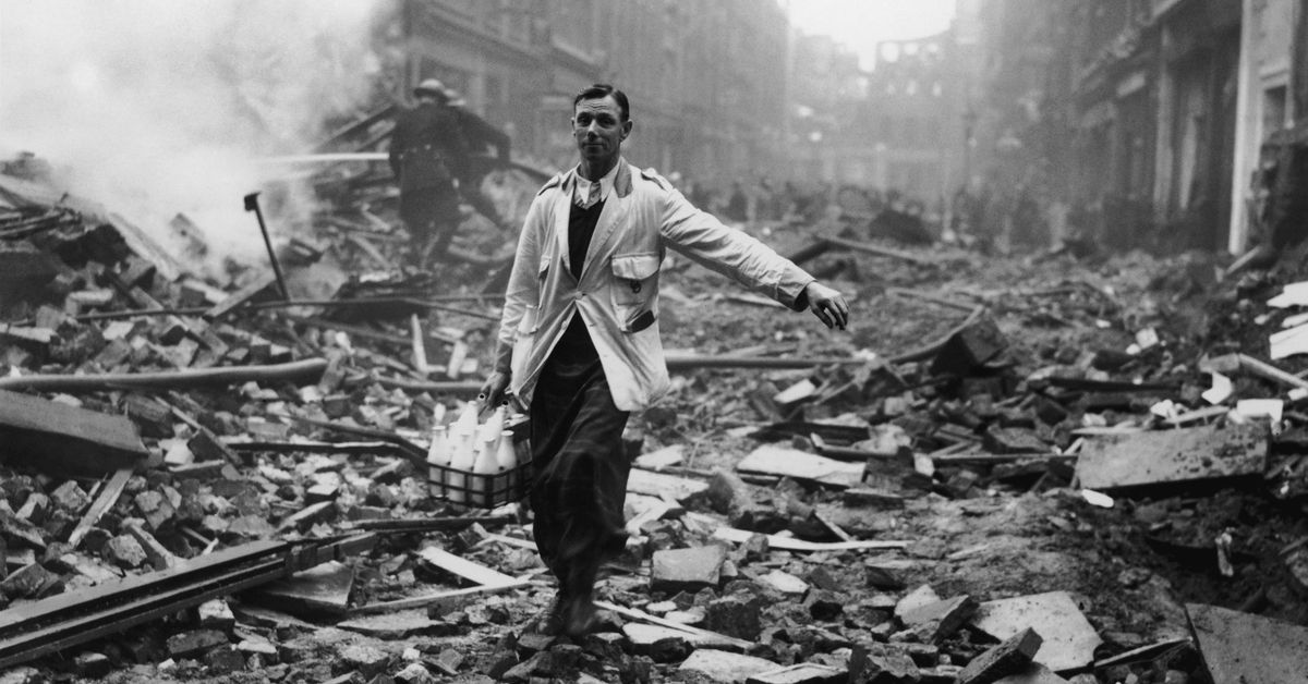 A milkman delivering milk in a street, devastated in a German bombing raid, in the Holborn area of London, 9th October 1940. Firemen are dampening down the ruins behind him. (Photo by Fred Morley/Fox Photos/Hulton Archive/Getty Images) (Fred Morley/Fox Photos/Hulton Archive/Getty Images)