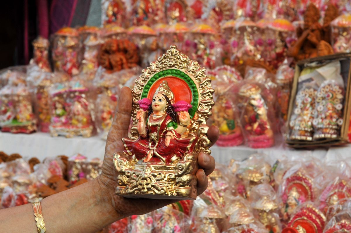 NOIDA, INDIA - OCTOBER 20: A lady buy idols of Goddess Laxmi and Lord Ganesha from roadside stalls ahead of Hindu festival Diwali at Sarojni Nagar Market on October 20, 2014 in Noida, India. Diwali also known as Deepavali and the festival of lights marks the return of Hindu god Lord Rama returned back to his kingdom after exile of 14 years. It is also a harvest festival as cropping season ends in Indian sub-continent and hence is associated with prosperity and wealth. (Photo by Sunil Ghosh/Hindustan Times via Getty Images) (Getty Images)