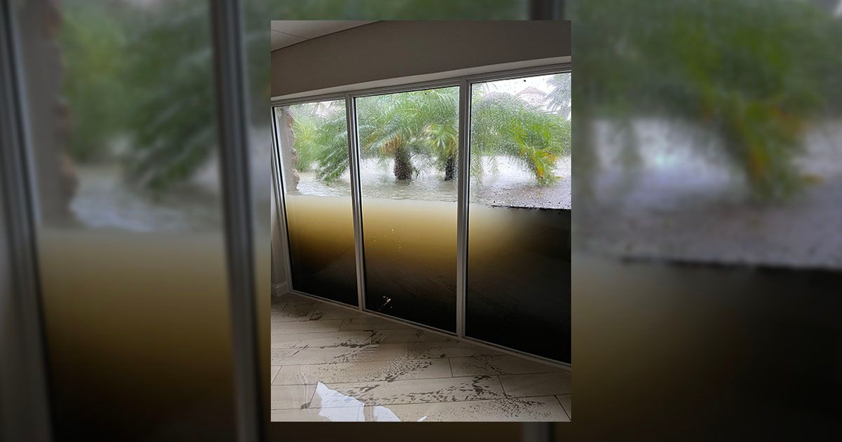 A photograph shows three windows holding back floodwaters from Hurricane Ian, according to Reddit. (@bothcoasts/Twitter)